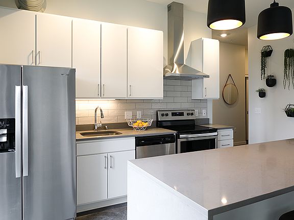 Beautifully appointed kitchen with quartz countertops and stainless steel appliances.