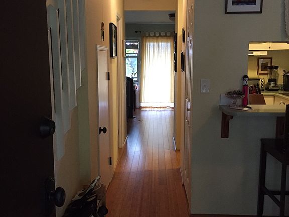 Hallway from entrance to kitchen, half-bath and living room.