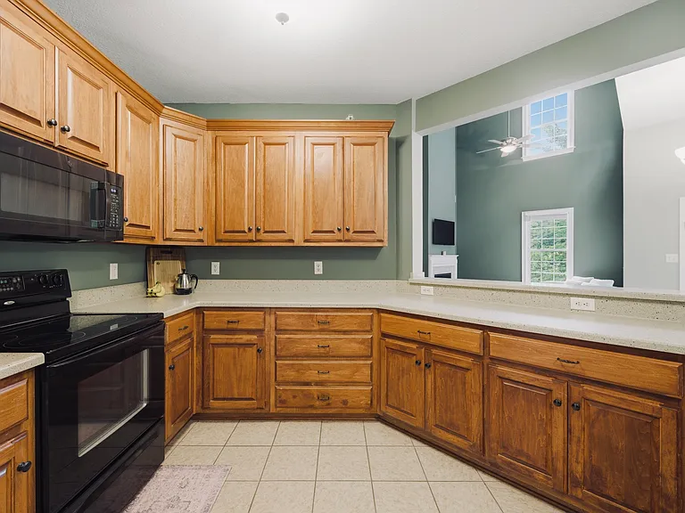 Kitchen with plenty of cabinet storage, range & black stainless steel microwave