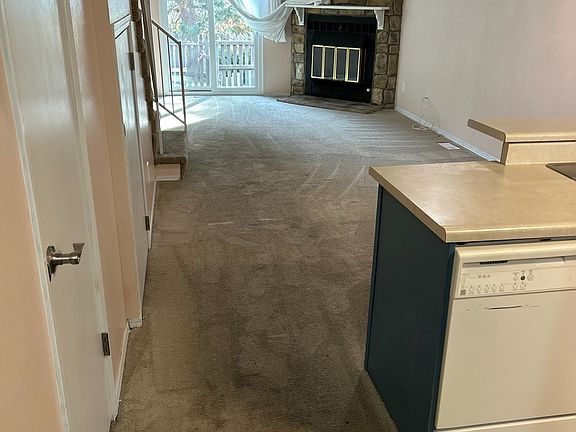 Half bath on left, kitchen on right, living room ahead with new sliding glass door