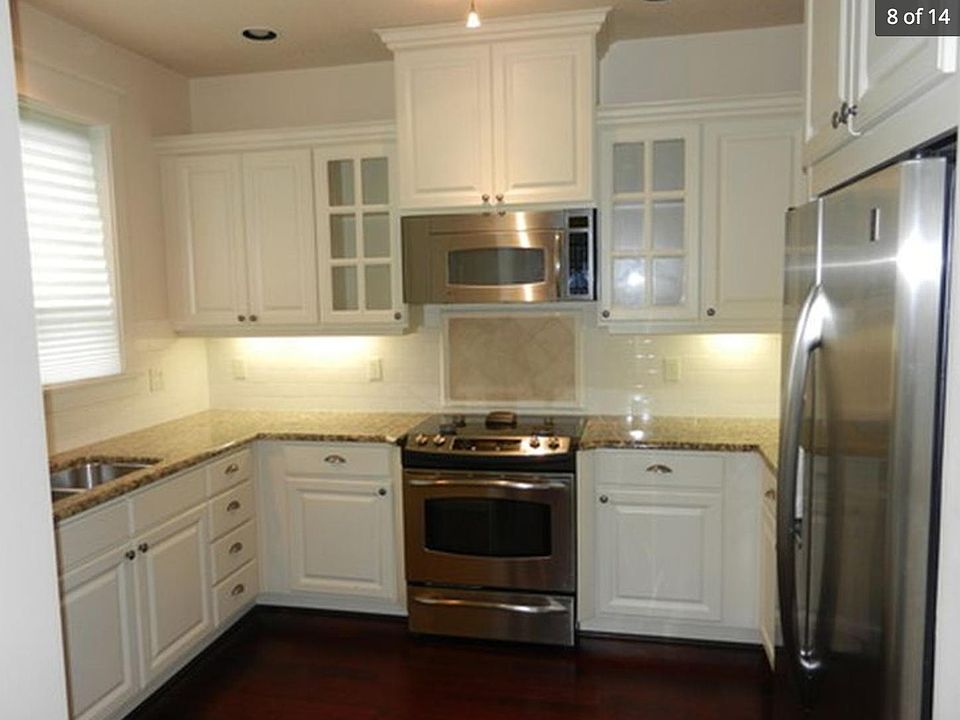 Kitchen with microwave, refrigerator and dishwasher. Plus 2.1 speakers built-in to the ceiling.