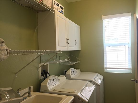 Separate laundry room with wash basin on main floor.