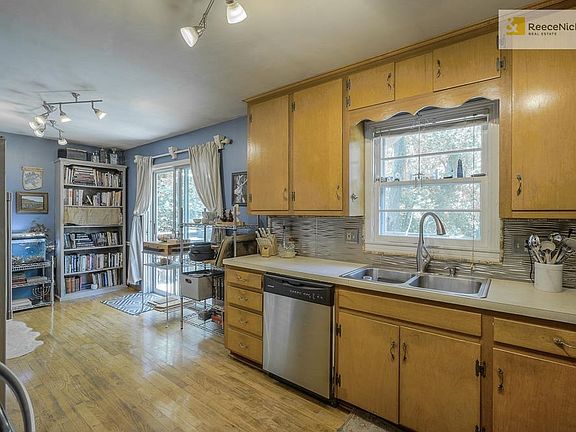 Hardwood floors, Stain Steel appliances, Spacious Eat In Nook leads to inviting deck perfect for entertaining.