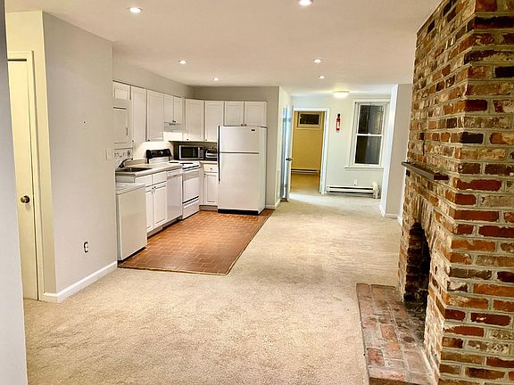 Living and kitchen area with working fireplace