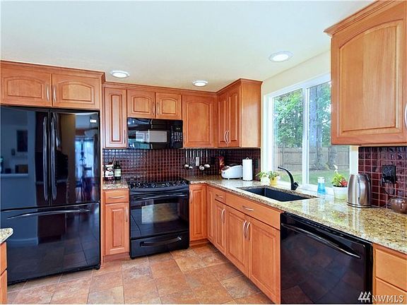 Granite counters, tile floor, solid beech cabinets and tile back-splash. All appliances stay!