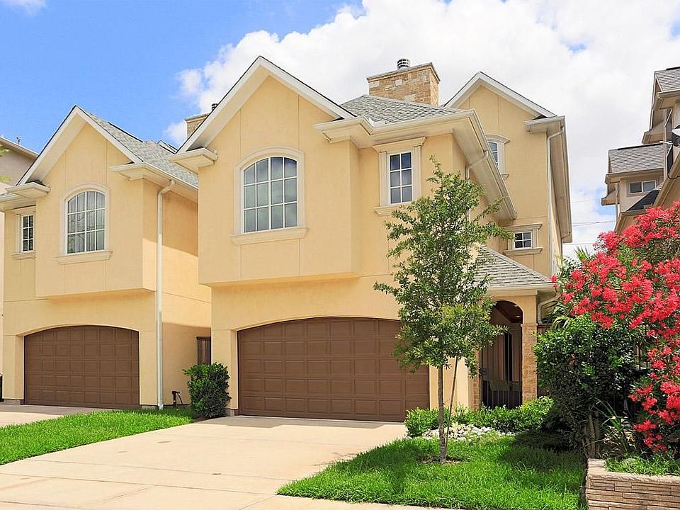 Front view of home, gated access to the front door to the right of the 2 car garage,