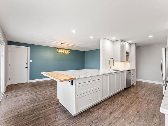 The kitchen, dining room and living room flow easily into one another while maintaining their own distinct spaces.