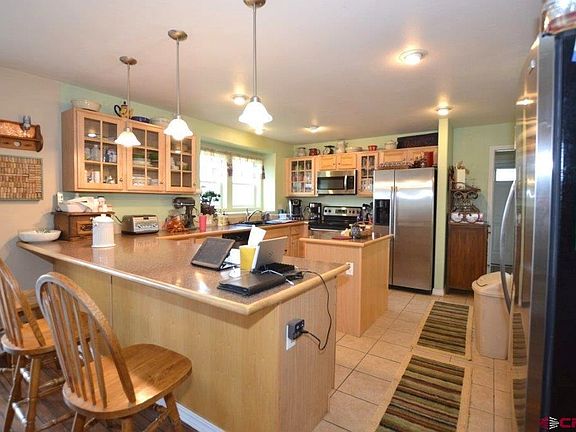 Island, bar seating, soft close cabinets, tile floors.