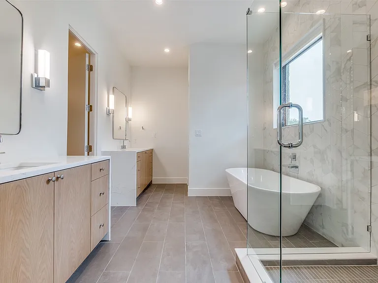 Primary bath offers dual vanities, soaking tub and walk-in shower.