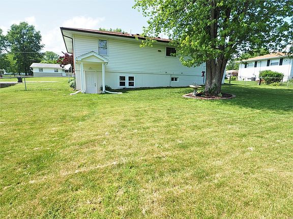 Home has a walk-out lower level with roof to protect from rain.