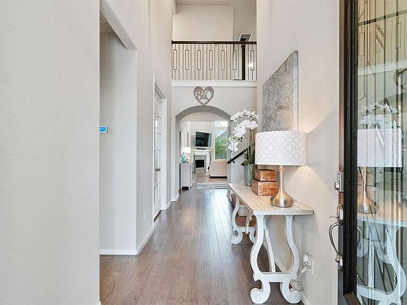 Step into this gorgeous foyer with two story ceilings and light wood floors.