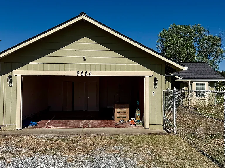 two car garage with storage cabinets, closet, and laundry hookups
