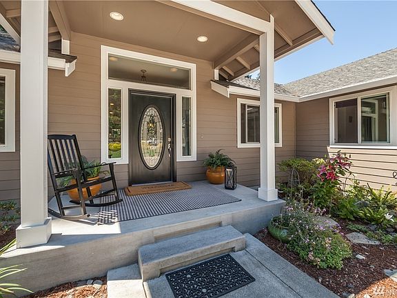 Charming covered front porch with beautiful flowers