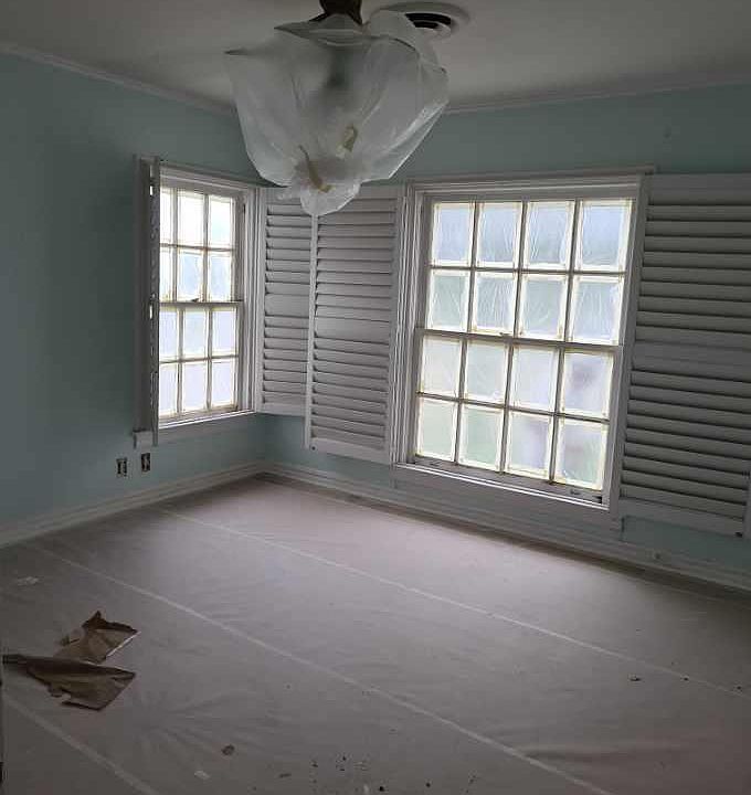 Front bedroom in middle of remodel; beautiful Shutters, all fixtures, fan etc will be new, original hardwoods