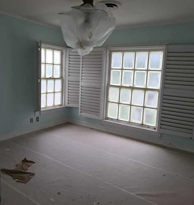 Front bedroom in middle of remodel; beautiful Shutters, all fixtures, fan etc will be new, original hardwoods