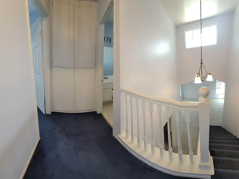 Landing Area with Entry to Upstairs Front Bedroom and Entry To Bathroom 2 (Curved Due To Panoramic Shot)