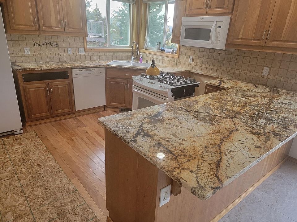 Kitchen. Plywood on floor was used to move the fridge in place. Stove is out of its place for counter installation