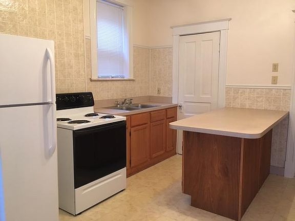 Newer Kitchen with Eating Bar, Stove, Refrigerator, Garbage 