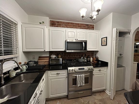 Kitchen is recently updated, with granite countertops, exposed brick, and in-unit washer and dryer.