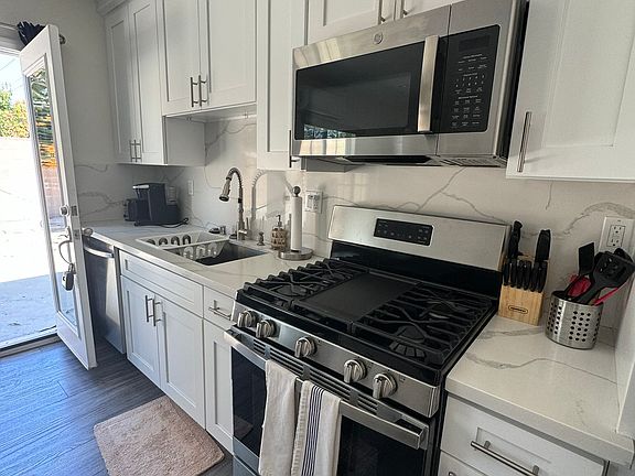 kitchen includes dishwasher, stove, microwave, refrigerator.