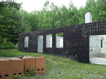 The seller is even leaving the brick for the outside of the home for you to finishbr