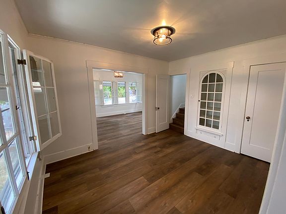 Dining room with pantry closet on right, display cabinet in middle, and stairs up to bedroom on left.