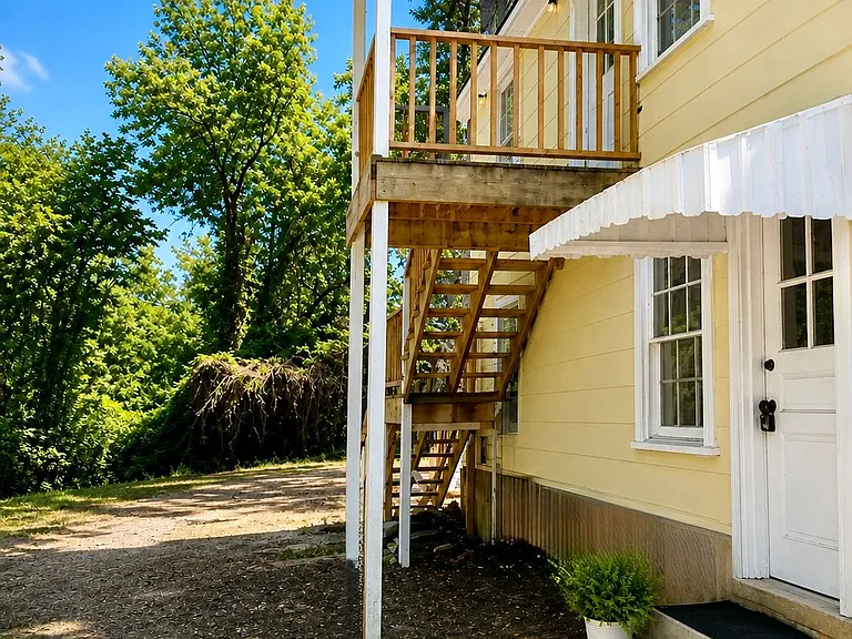 Dedicated entrance for Unit D (upstairs) private access without shared interior spaces.
