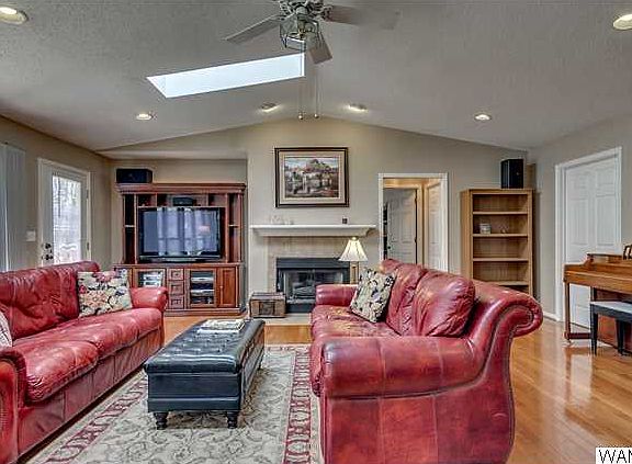 Another view of large living room.   Hallway to the right of fireplace has door to the right going downstairs and straight ahead to large master suite.