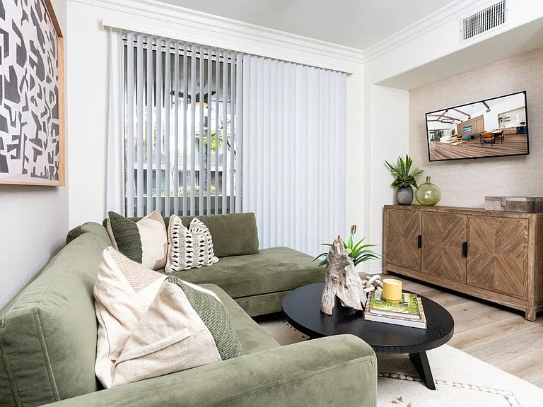 Comfortable Living Room with Mounted TV, Media Console, and Cozy Decor