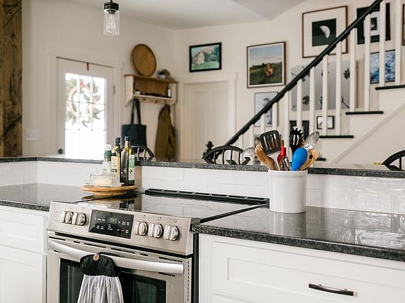 Back door to deck; closed door to downstairs full bathroom, and steps leading to all 3 bedrooms and large upstairs full bathroom.