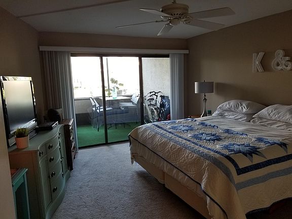 Bedroom and enclosed lanai which is also accessible from liv