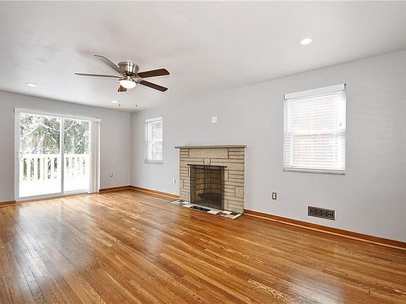 The large living/family room features new windows for extra natural light AND a brand-new sliding glass door that leads to the N