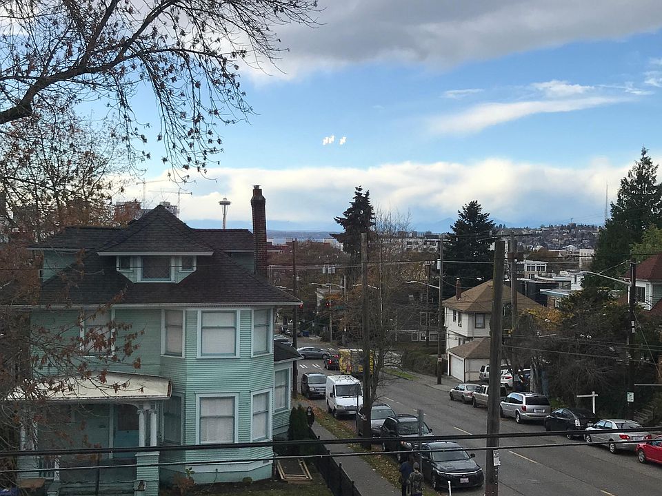 West facing living room window with view of Downtown, Space Needle, Puget Sound, and Olympic mountains
