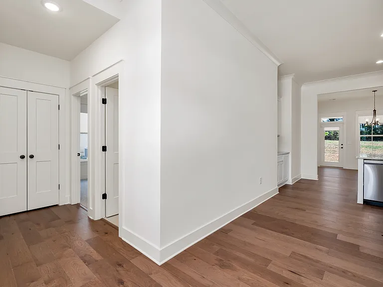 Entrance area at the front of the home. The double door open to a full linen closet.