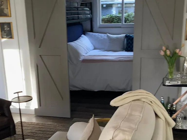 Double barnyard door that opens/closes to a small bedroom/study off to side of living room