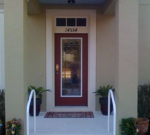 Custom Glass entry door with blue ceilings on all outside spaces.