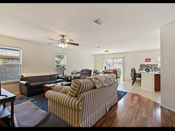 Living room featuring ceiling fan and light wood-type flooring