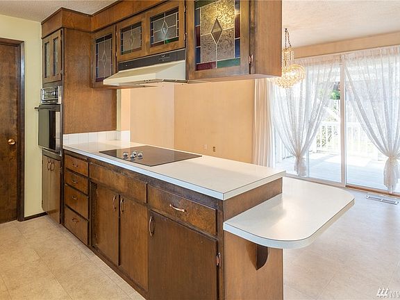 Other side of kitchen looking into family room and eating area.