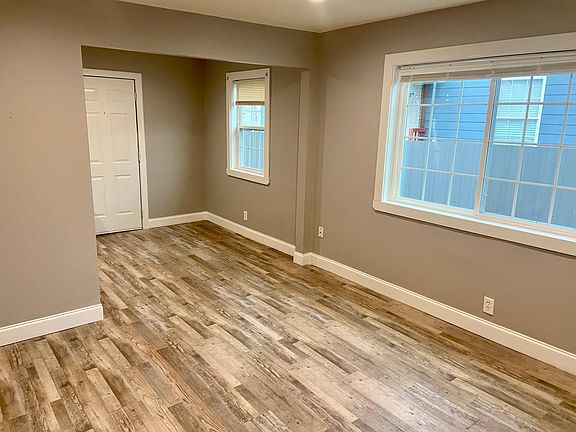 Living room and kitchen nook along with backyard door