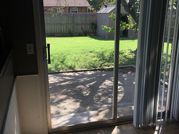 Dining area with sliding patio door overlooking backyard