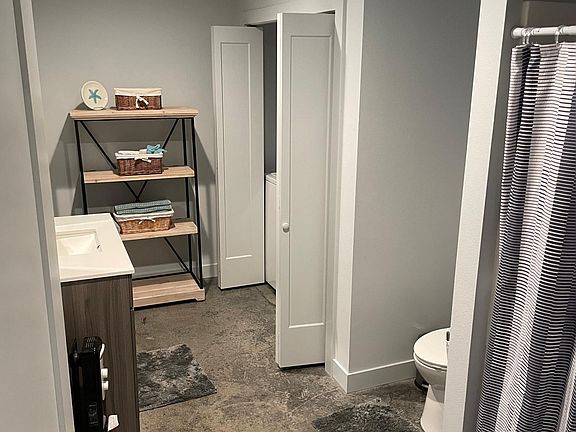 Bathroom with shower and washer and dryer in the closet