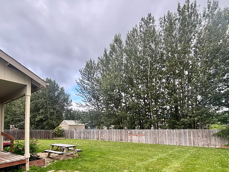 Fully fenced back yard, deck, grill, and picnic table