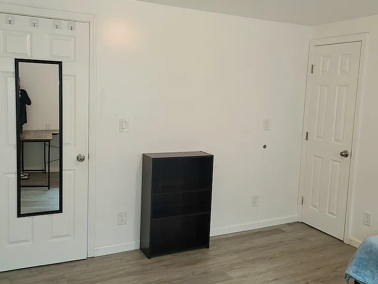 View of bedroom, taken from corner where desk is staged.