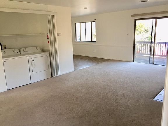 Spacious living room with Washer and Dryer and raised deck.