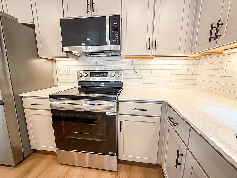 Modern kitchen with stainless steel appliances, large island, and plenty of cabinet space_your dream cooking space!
