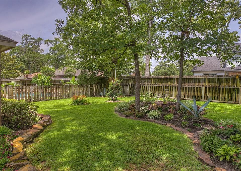 Landscaped back yard with fence.