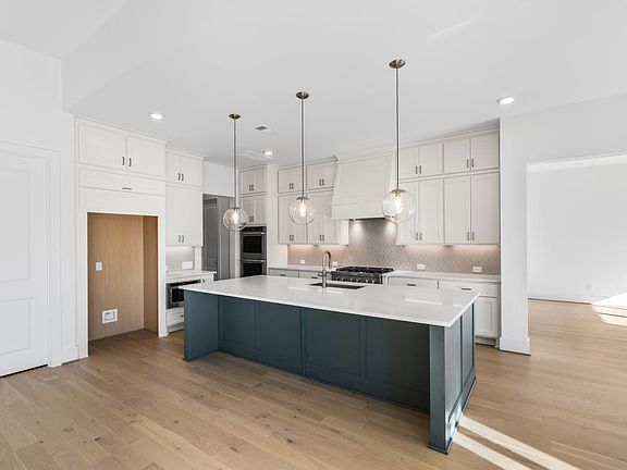 Beautifully painted kitchen island with upgraded fixtures