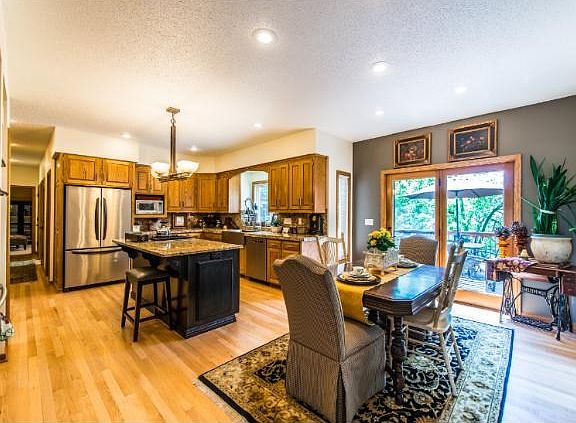 Spacious kitchen includes center island dining space and a large walk-in pantry. Access to the deck for additional outdoor enjoyment is opened from the informal dining space.
