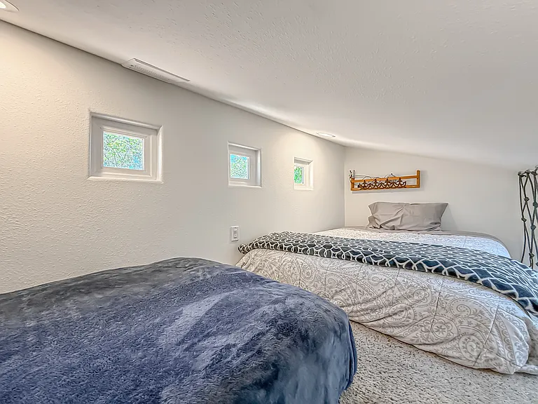 Loft with a full bed and a single bed