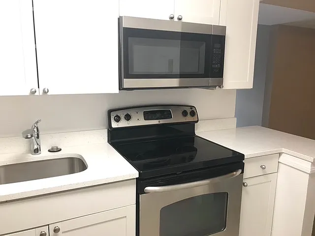 Stainless steel appliances and new white kitchen
